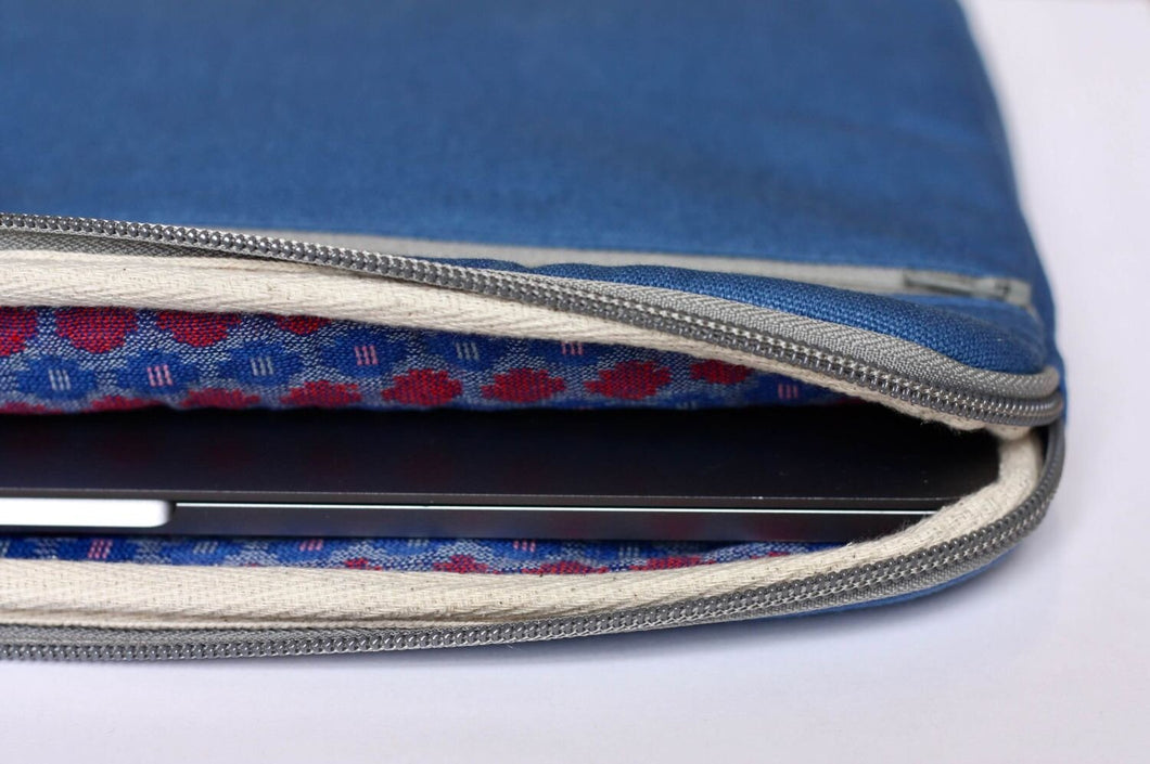 Inside view of 13 inch MacBook laptop sleeve showing the pink and blue decorative patterned fabric lining.