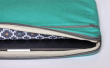 Load image into Gallery viewer, Interior shot of teal laptop 13 inch case showing the black and white Dhaka pattern fabric.
